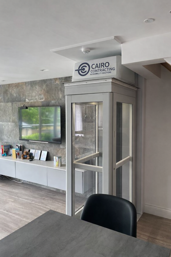 Modern shaftless home elevator installed in a Vancouver residence with Cairo Contracting Accessibility Solutions branding on the upper panel