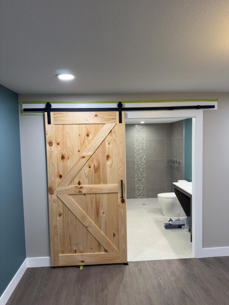 Modern ADA bathroom renovation with curbless shower and safety grab bars